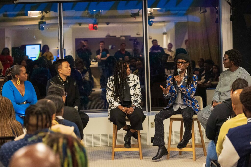 Photo of a panel sitting down in conversation. Pictured from left to right: Dr. Charisse Beaumont, Eric Wong, Ebonie Smith, Nile Rodgers and Ọpẹ́yẹmí Irédùmarè.